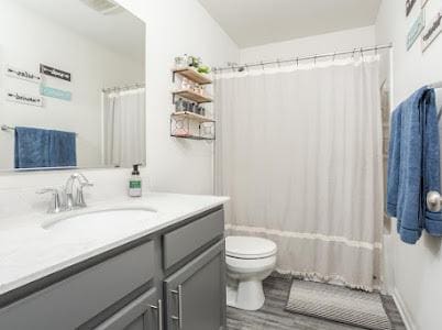 26011 S Old Farm Ct, Channahon, IL 60410 - bathroom featuring vanity, wood finished floors, toilet, and shower / bath combo with shower curtain
