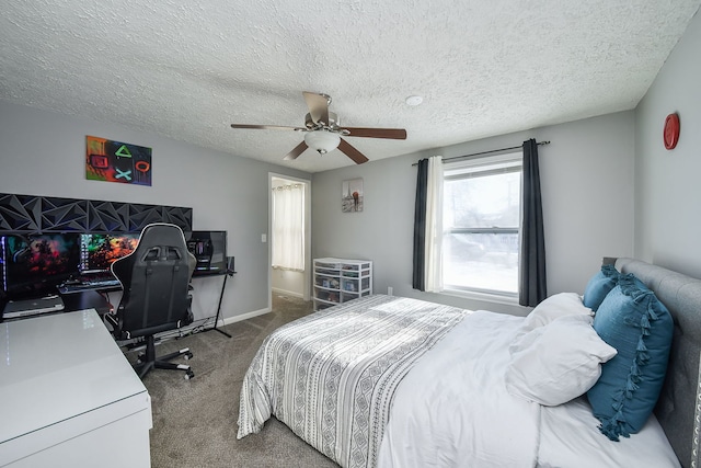 carpeted bedroom with a textured ceiling and ceiling fan