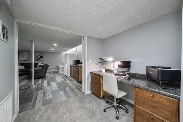 office area featuring wood-type flooring and a textured ceiling