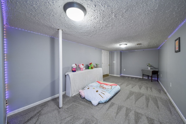 carpeted bedroom featuring a textured ceiling