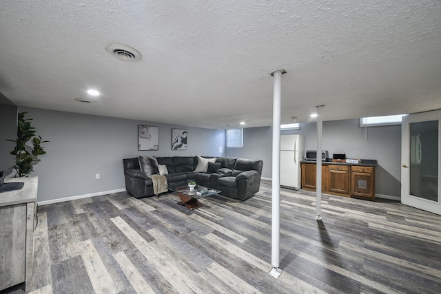 living room featuring hardwood / wood-style floors and a textured ceiling