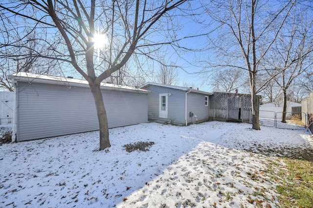 view of snow covered rear of property