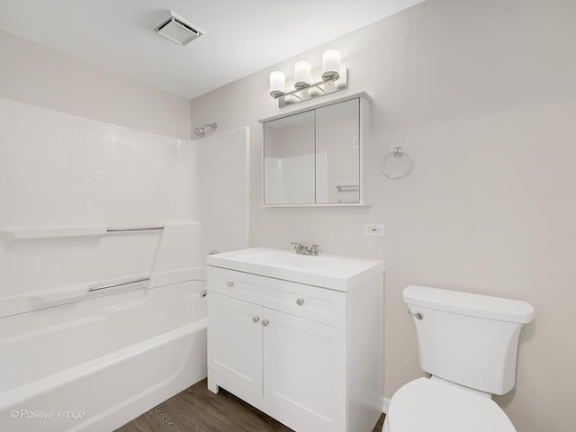 full bathroom featuring hardwood / wood-style flooring, vanity, toilet, and tub / shower combination