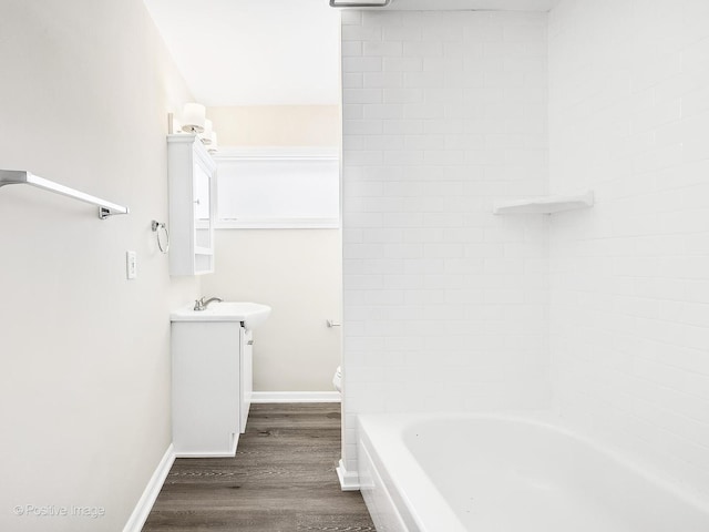 full bathroom featuring vanity, toilet,  shower combination, and wood-type flooring