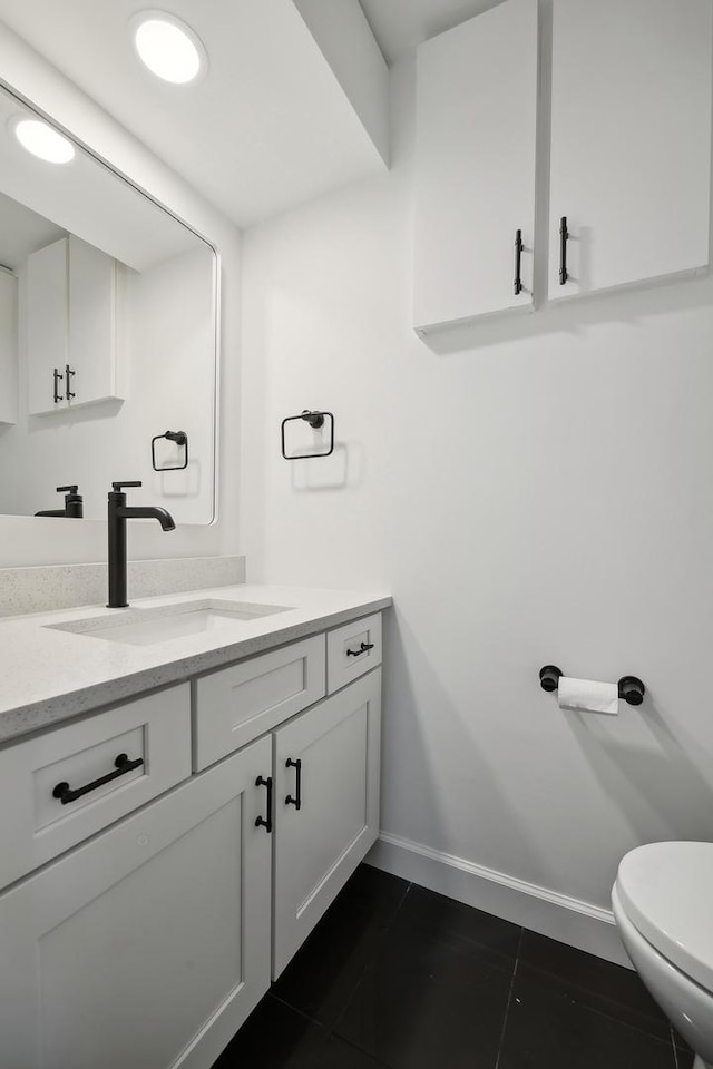 bathroom with tile patterned floors, vanity, and toilet