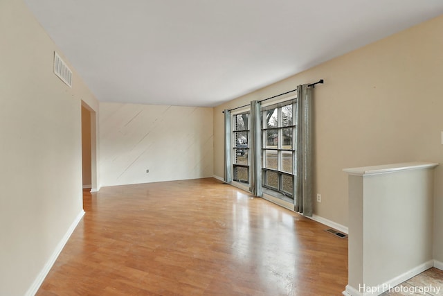 empty room with light hardwood / wood-style flooring