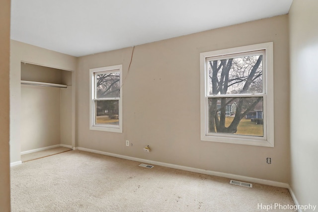 unfurnished bedroom featuring carpet floors and a closet