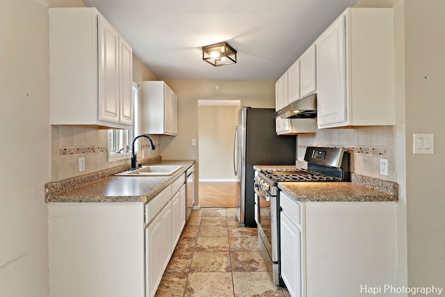 kitchen with sink, decorative backsplash, white cabinets, and appliances with stainless steel finishes