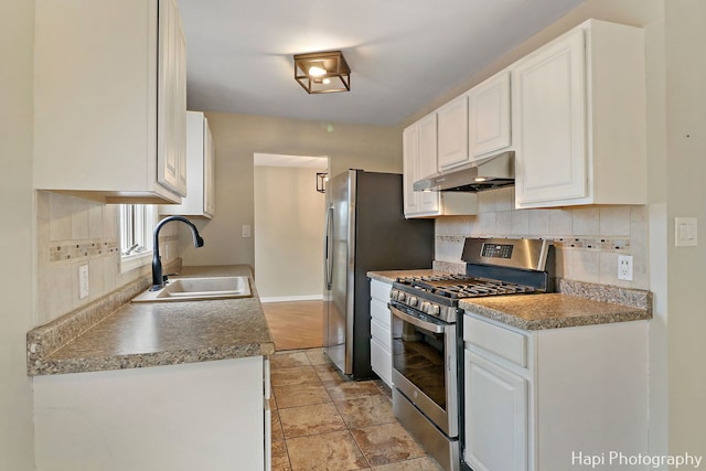 kitchen featuring white cabinetry, sink, decorative backsplash, and gas stove