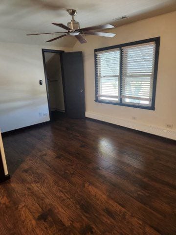 unfurnished room with ceiling fan and dark hardwood / wood-style floors