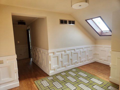 bonus room featuring hardwood / wood-style flooring and vaulted ceiling with skylight