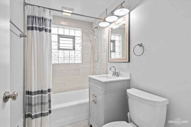 full bathroom featuring vanity, shower / tub combo with curtain, and toilet