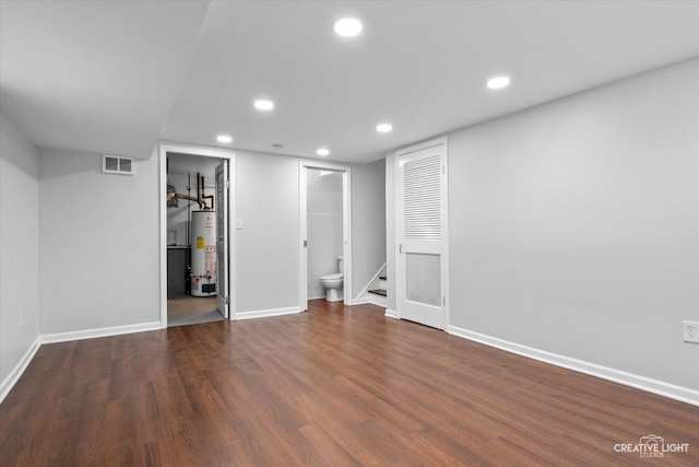 interior space with water heater and dark wood-type flooring