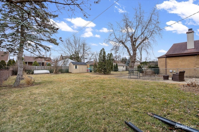 view of yard with a patio and a shed