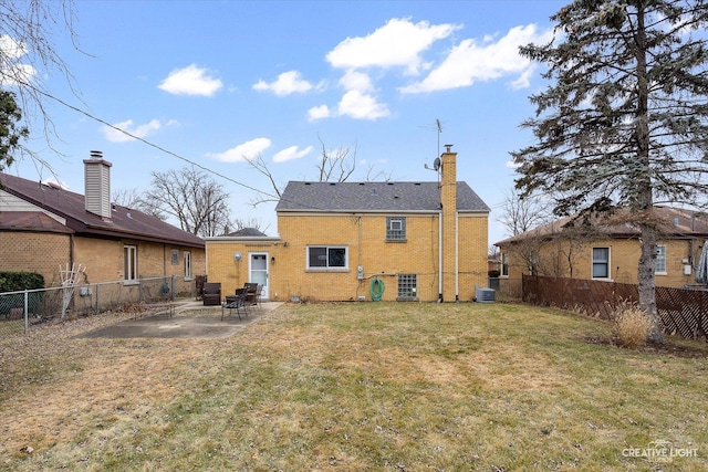 back of property with a patio, a yard, and cooling unit