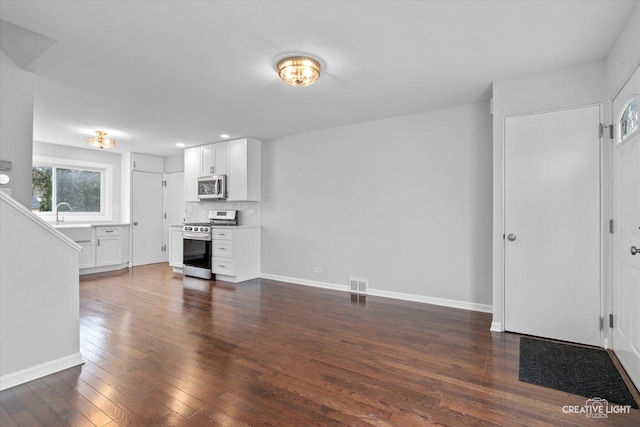 unfurnished living room with dark hardwood / wood-style floors