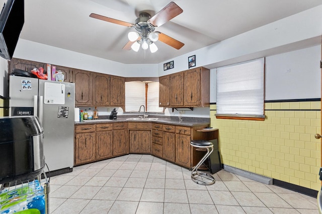 kitchen with sink, ceiling fan, and stainless steel refrigerator with ice dispenser