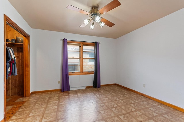 unfurnished bedroom featuring baseboard heating, ceiling fan, and a closet