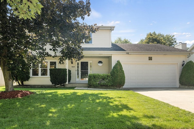 view of front facade featuring a garage and a front yard