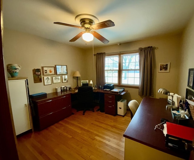 home office featuring wood-type flooring and ceiling fan