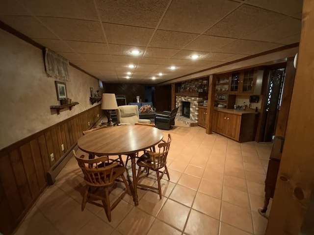 dining room with baseboard heating and a fireplace