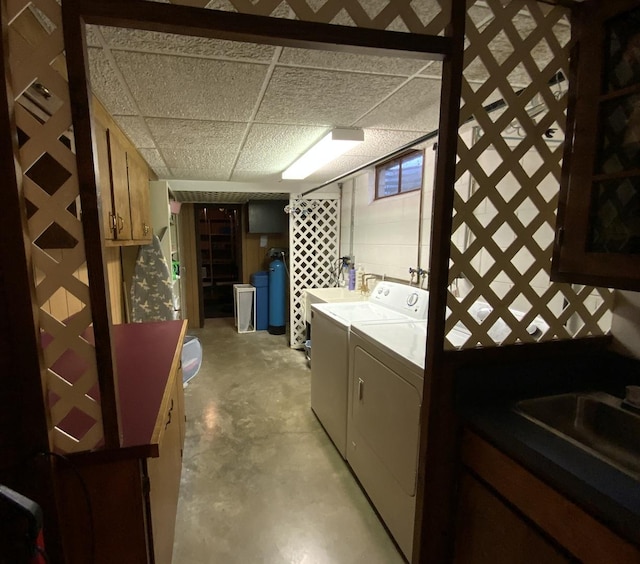 washroom with separate washer and dryer and sink