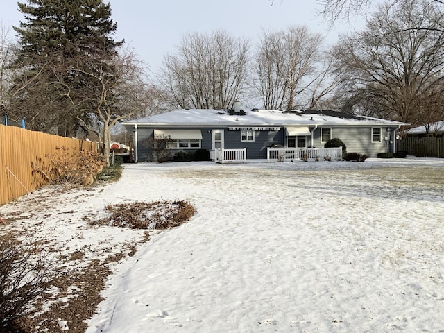 view of snow covered rear of property