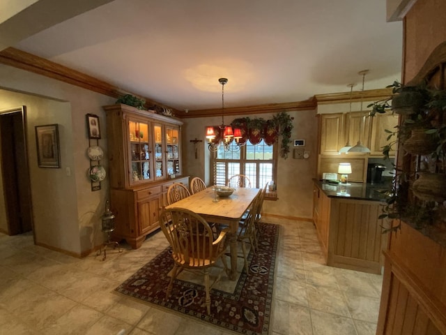 dining room with ornamental molding and a chandelier