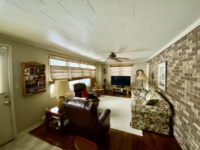 living room with crown molding, brick wall, ceiling fan, and hardwood / wood-style flooring