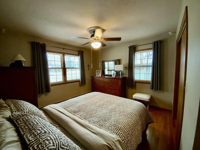 bedroom with dark wood-type flooring and ceiling fan