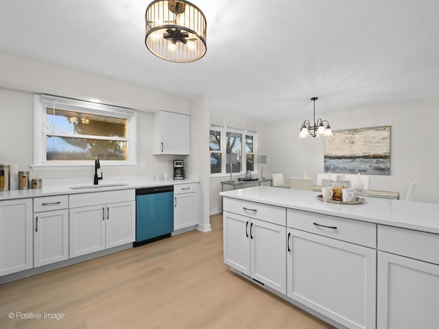 kitchen with sink, white cabinetry, decorative light fixtures, a chandelier, and dishwasher