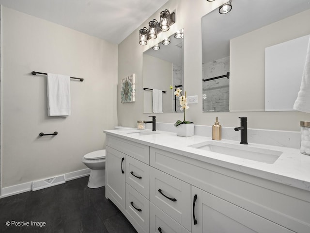 bathroom with vanity, toilet, and walk in shower