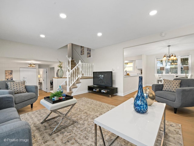 living room featuring an inviting chandelier and light wood-type flooring