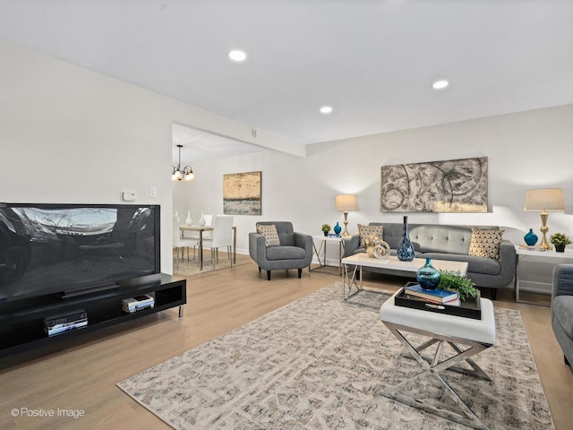 living room featuring an inviting chandelier and wood-type flooring