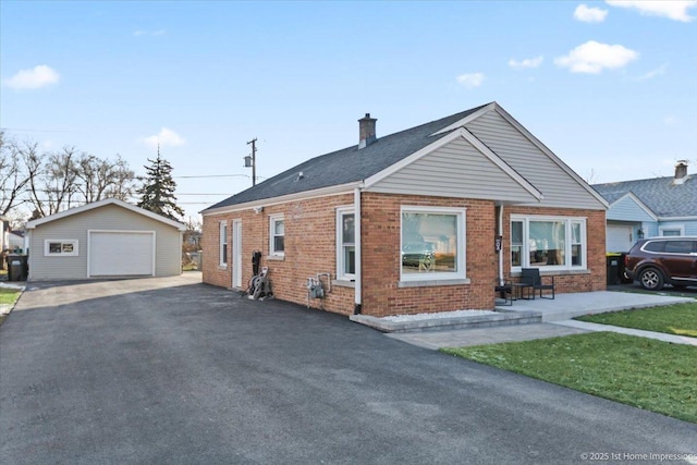 view of front facade with an outbuilding and a garage