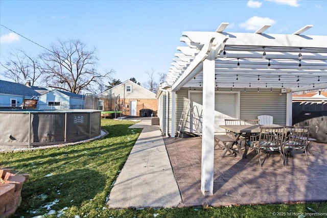 view of patio with a trampoline and a pergola