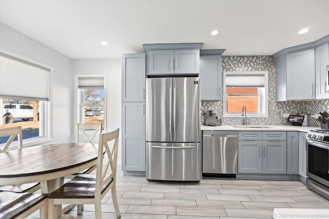 kitchen featuring sink, gray cabinets, and stainless steel appliances