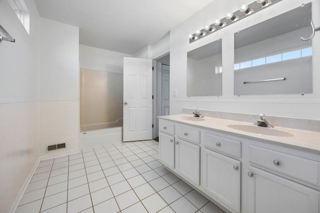 bathroom with tile patterned flooring, vanity, and plus walk in shower