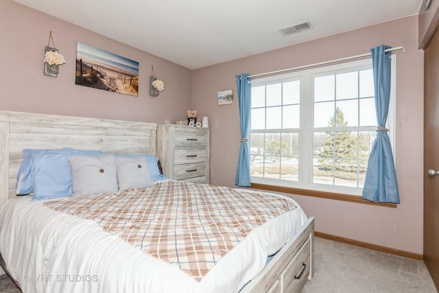 bedroom featuring multiple windows and light colored carpet