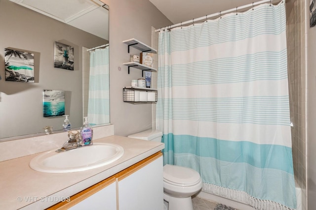 bathroom featuring vanity, curtained shower, and toilet