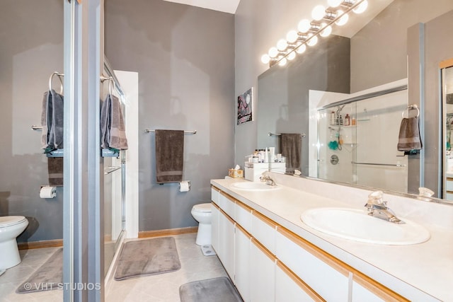 bathroom featuring a shower with door, vanity, tile patterned flooring, and toilet