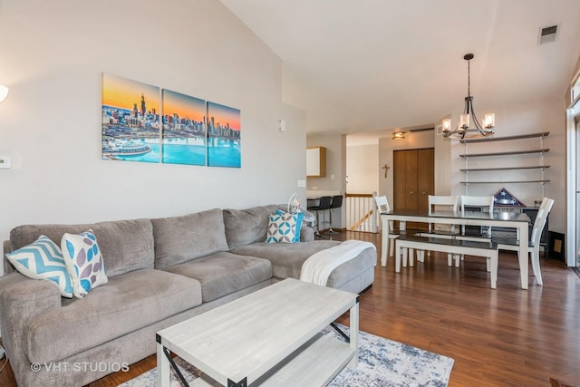 living room featuring hardwood / wood-style flooring and an inviting chandelier