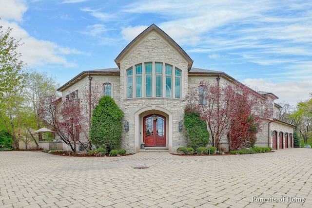 view of front of home with a garage and french doors