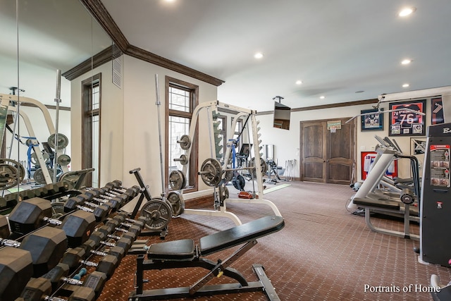 exercise room featuring crown molding