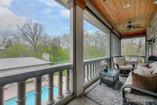 sunroom / solarium with wood ceiling and ceiling fan