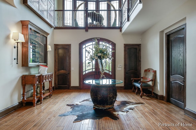 entryway featuring light hardwood / wood-style floors and a high ceiling