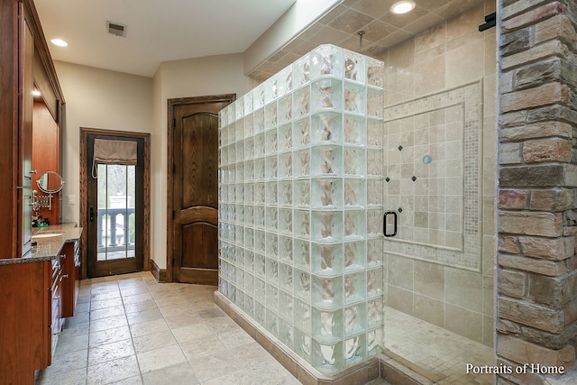 bathroom featuring vanity and an enclosed shower