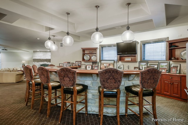 bar with pendant lighting and carpet