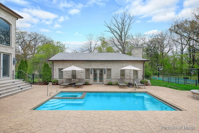 view of swimming pool featuring a patio area and french doors