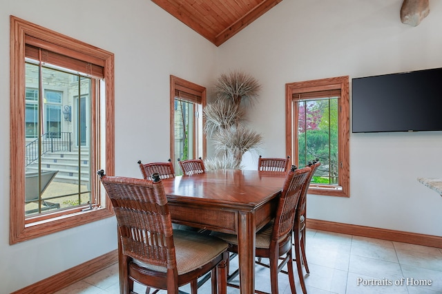 dining space featuring high vaulted ceiling, light tile patterned floors, and wooden ceiling